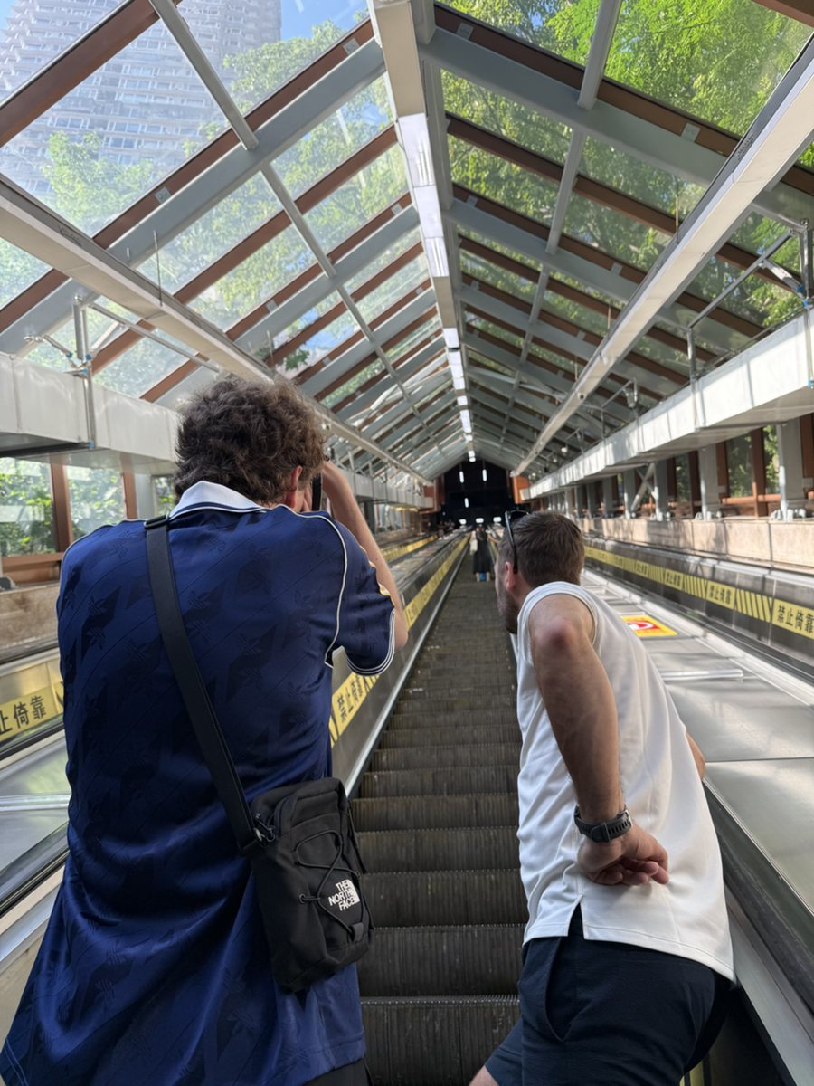 Guests riding the Crown Escalator through old Chongqing
