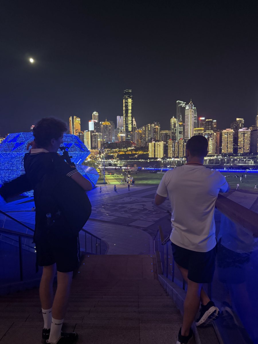 Guests taking in Chongqing's illuminated skyline from a local night viewpoint