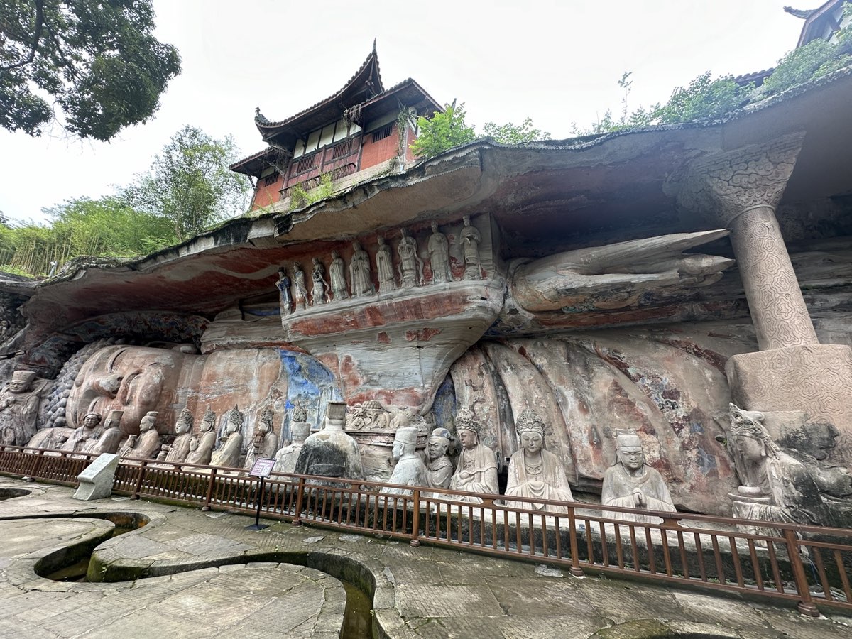 A wide view of the cliff-carving complex at Baodingshan