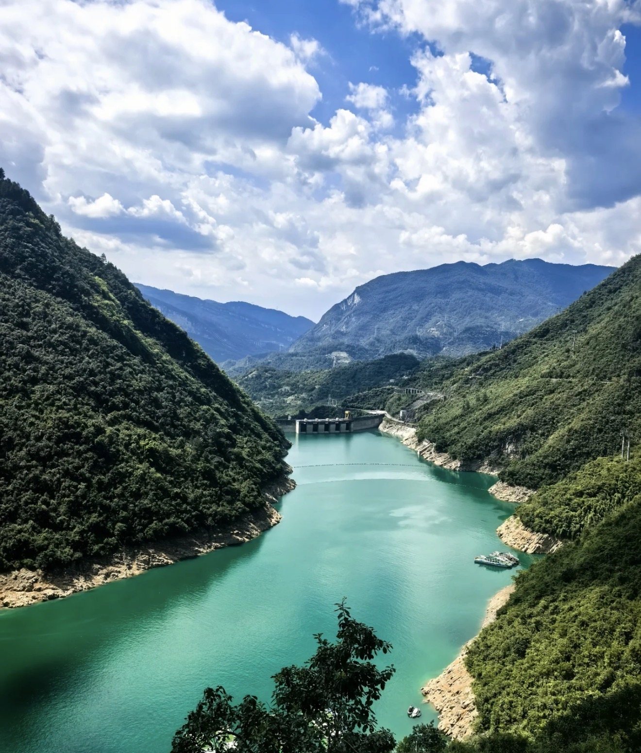 The emerald Furong River winding between forested karst cliffs